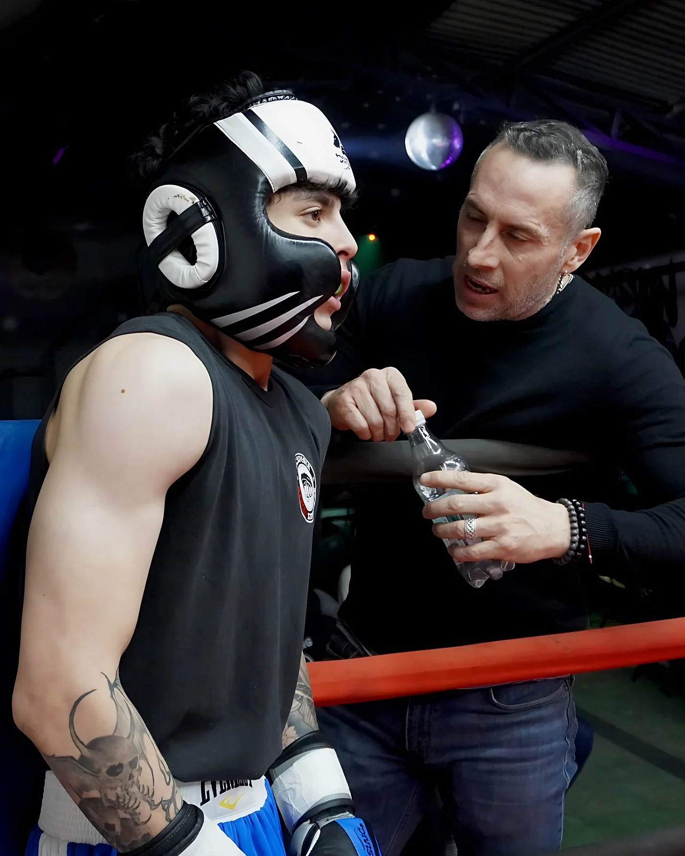 Coach dando indicaciones a su alumno en el ring
